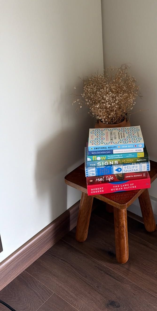 Books and dried flowers on a wooden stool