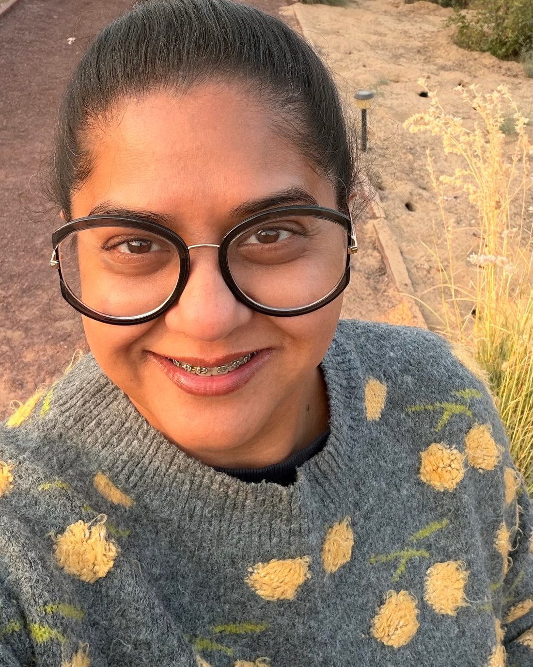 Kavea smiling in a garden in Rajasthan